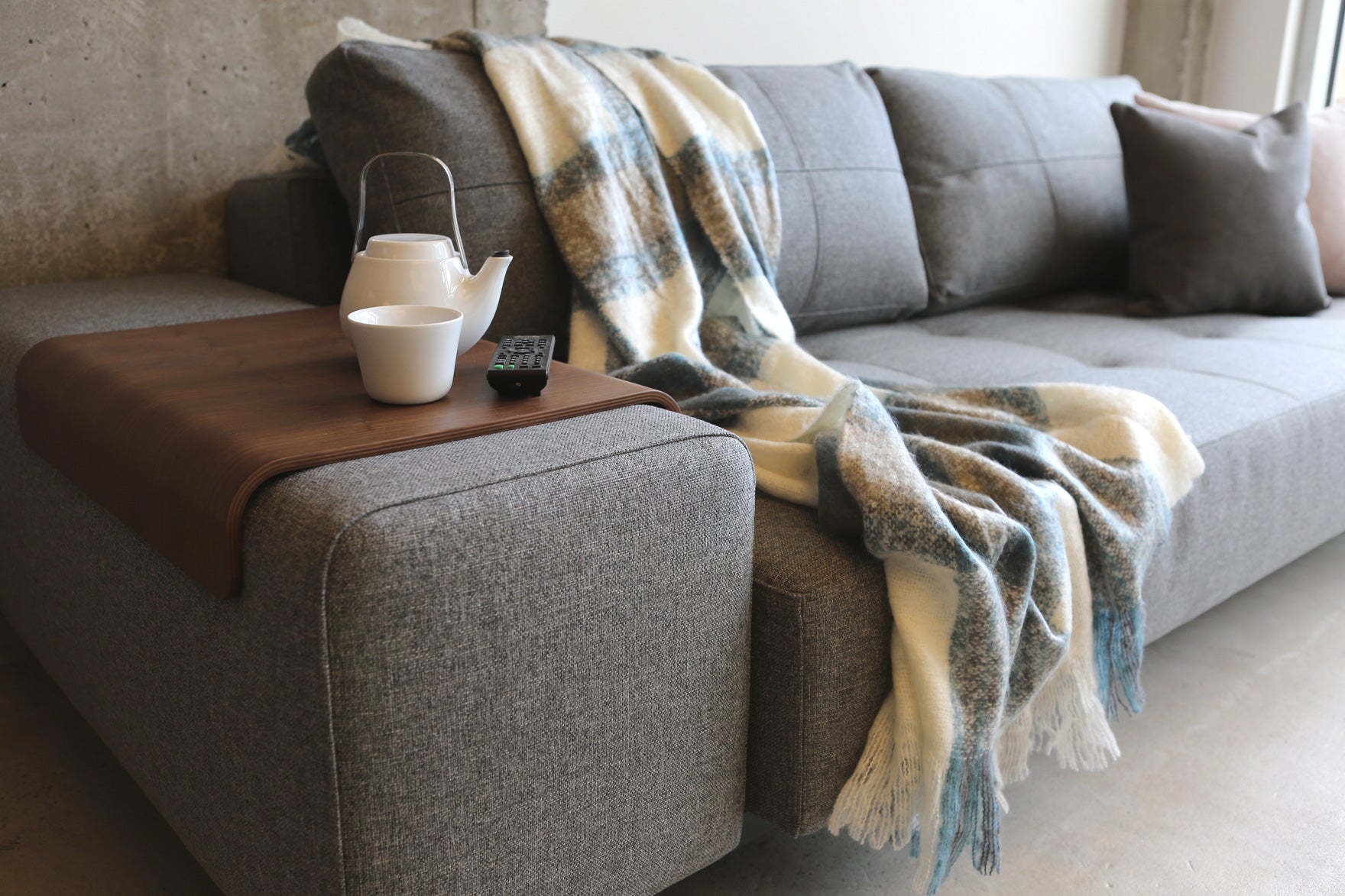 Soho Sofa Bed in grey with one walnut arm tray