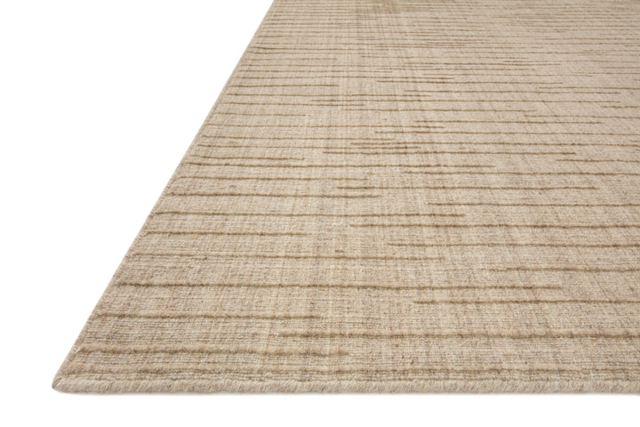 Textured beige Brooks area rug on a white background