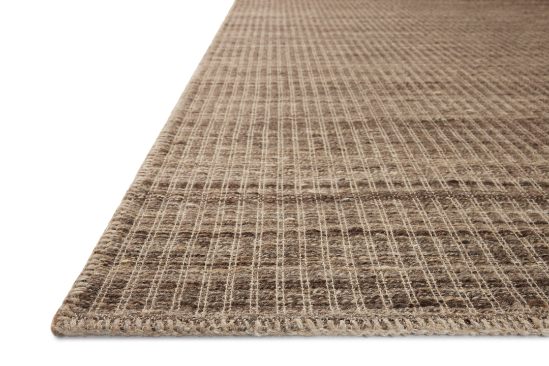 Close-up of a textured brown rug on a white background