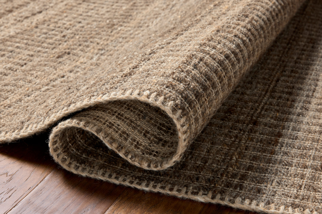 Close-up of a textured Elm bark coloured rug on a wooden floor