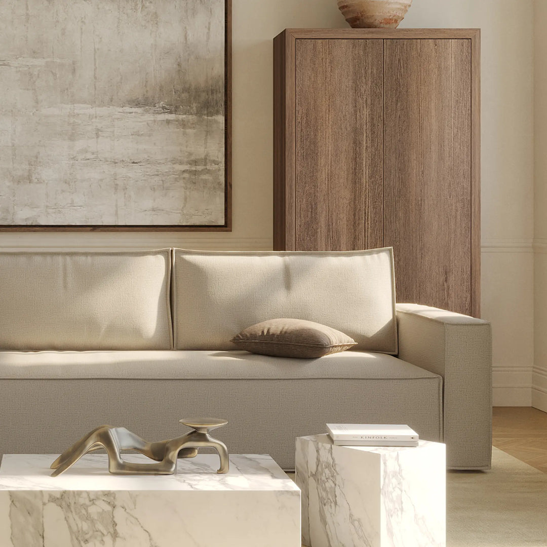 Modern living room with beige Play sofa bed , marble coffee table, and abstract painting.