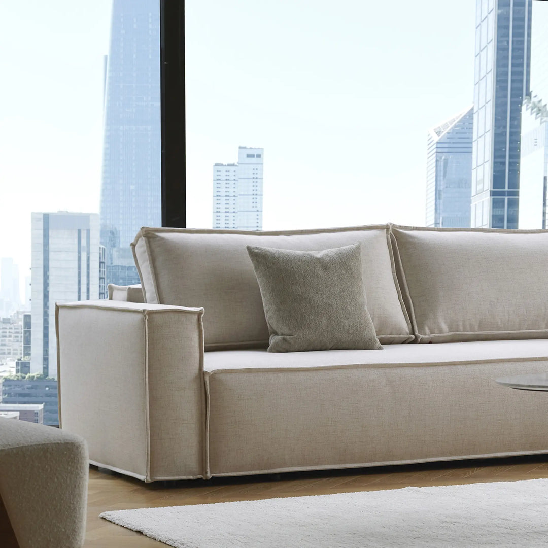 Beige Play sofa  bed with cushions in a modern living room with cityscape view