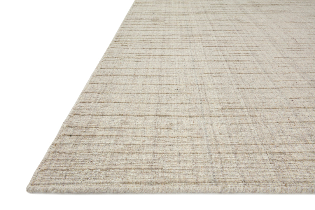Textured stone beige rug on a white background