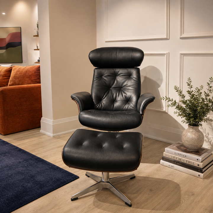 A front view TimeOut black leather swivel recliner with a matching ottoman, offered by Thesofabedstore.com is shown in a styled living room setting with wood floors, a blue rug, a sofa, and a potted plant.