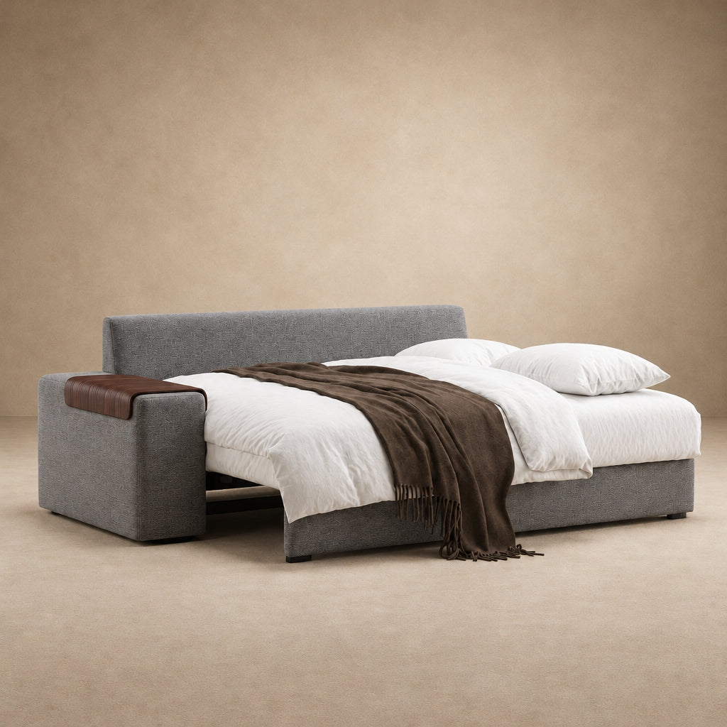 Vilander Sofa Bed with Wide Arms in 282 Warm Grey textured upholstery, featuring walnut wood armrest accents and a modern design, shown against a warm beige studio background.