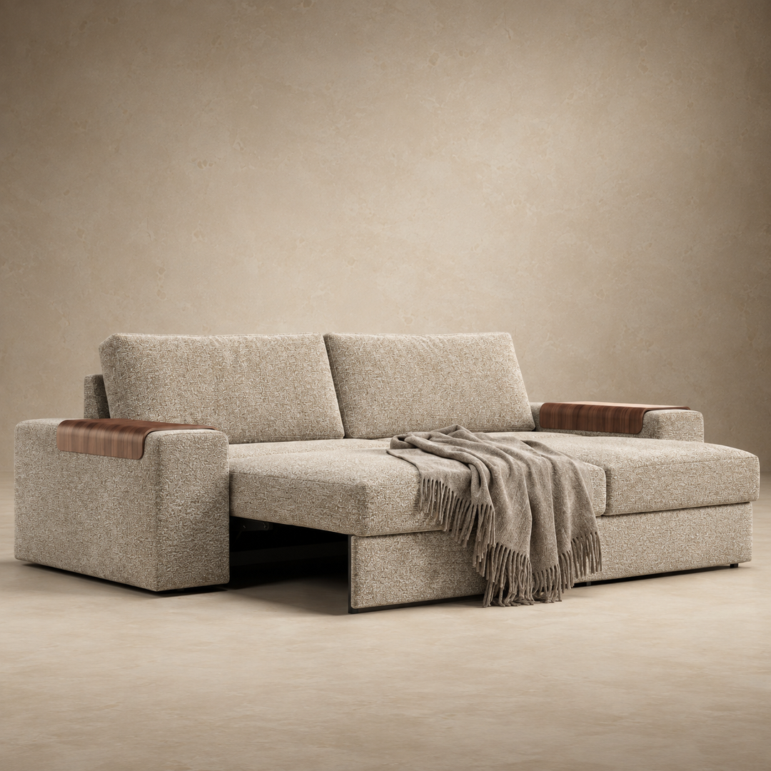 Vilander Sofa Bed with Wide Arms in 366 Khaki textured upholstery, featuring walnut wood armrest accents and a modern design, shown against a warm beige studio background.