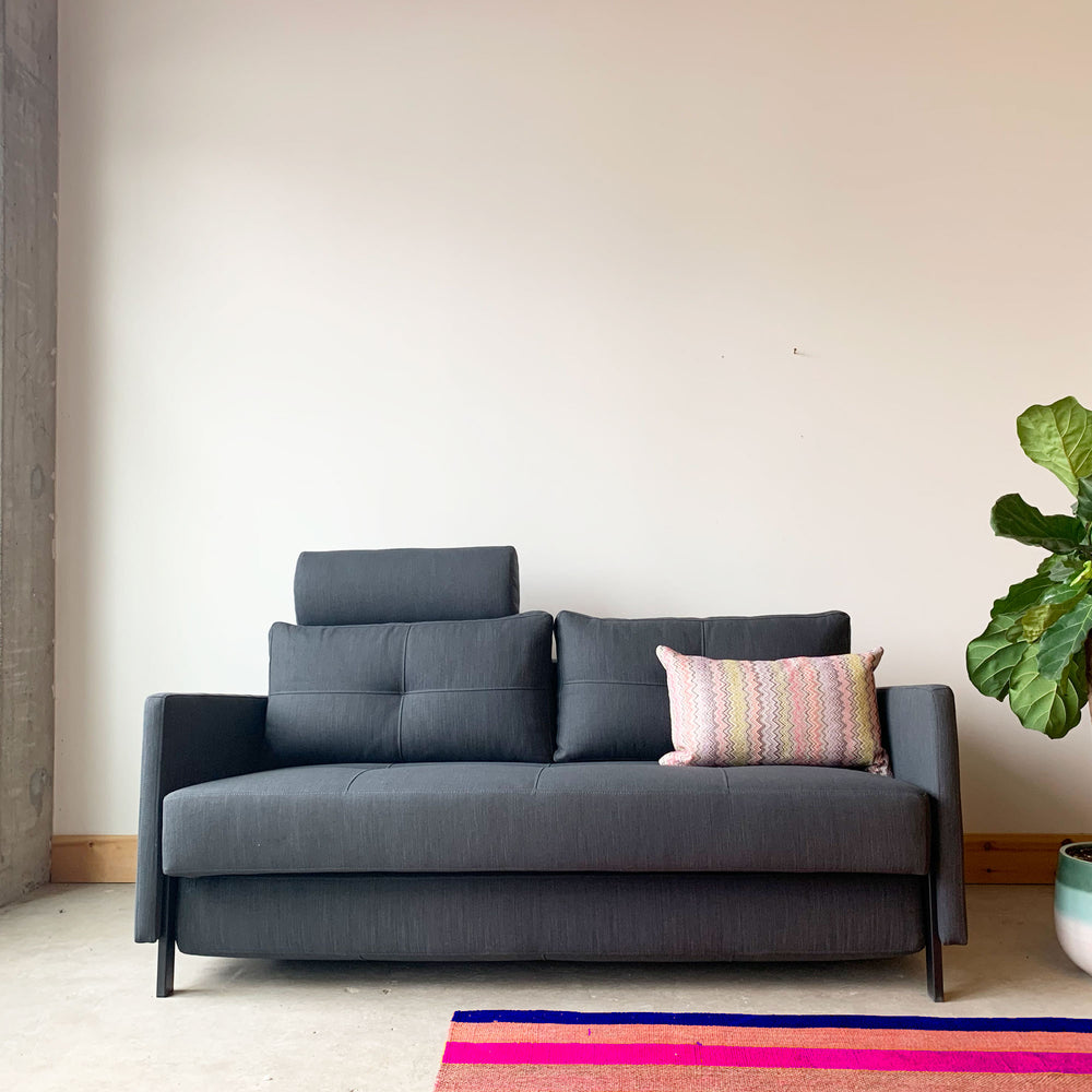 Strerch sofa bed in anthracite with a headrest