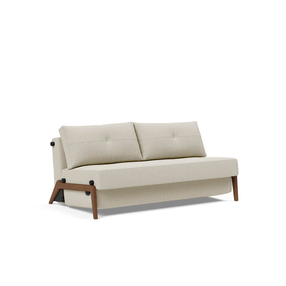 A beige upholstered queen-sized sofa bed with wood legs, in a fully unfolded state, showcasing its queen bed size.
